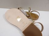 pair of women ' s gold sandals on a white surface