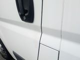 a close up of a white truck with a black door handle