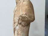 a stone statue of a man standing in a room