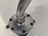 a close up of a metal pipe on a white surface