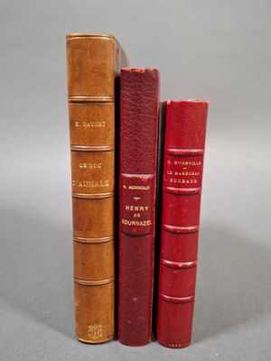 trois livres sont empilés sur une table
