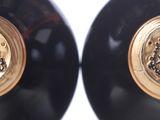 two black vases with gold trims on them