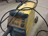 a welding machine that is sitting on the ground