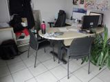 a table with two chairs and a laptop on it