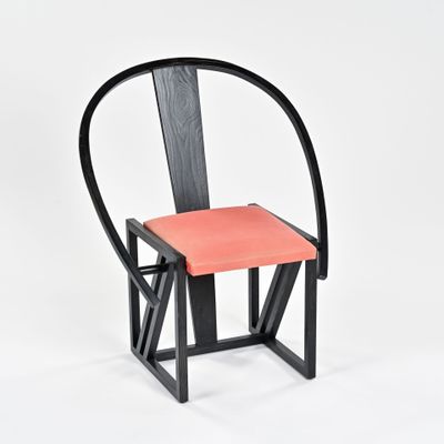 an image of a black chair with a red seat on a white background
