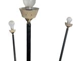three lights that are on top of a pole