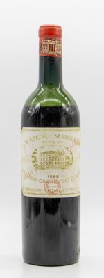 une vieille bouteille de vin posée sur une surface blanche