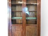 an image of a wooden cabinet with glass doors and shelves
