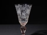 crystal wine glass on a black table with a black background