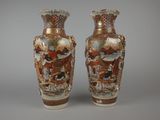 two vases sitting side by side on a gray surface