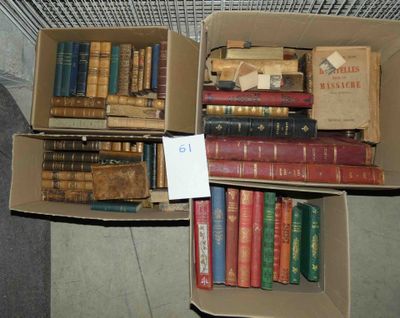 two boxes of books sitting on the floor next to each other