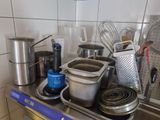 many pots and pans on the stove in the kitchen