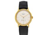 an 18k yellow gold wrist watch with a white dial
