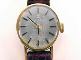 an image of a close up of a wrist watch on a white surface