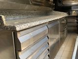 a kitchen with a stove, oven, and counter in it