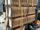 many boxes of files on a rack in a warehouse