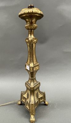 an antique brass table lamp with a glass shade on top