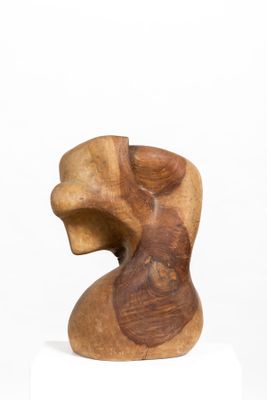 wooden sculpture of a woman ' s head on a white pedestal