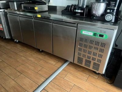 a kitchen with stainless steel appliances and appliances on the counter