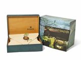 a box with a watch inside of it and a box with an envelope inside