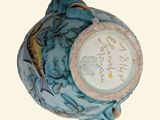 a blue vase with a clock on the top of it