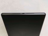 the back of a black laptop computer sitting on top of a white surface