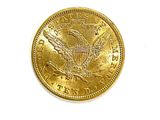 an image of a gold coin on a white surface