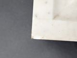 a close up view of a white toilet with a black seat