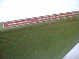 a close up of a green book with a red label on it