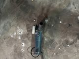 a drill on the ground next to a wall