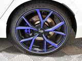a close up of a white car with blue rims