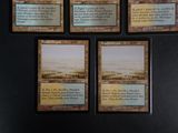 four cards on a black board with a picture of a desert