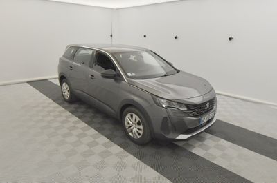 a grey suv parked in a garage with a checkered floor