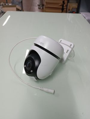a white camera sitting on top of a glass table