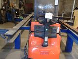 a forklift that is sitting in the middle of a room