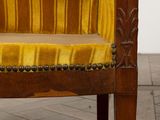 a yellow chair that is sitting on a wooden floor