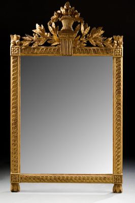 an ornately carved mirror with a bird and flower decoration