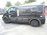 a black van that is parked in a parking lot