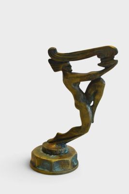 bronze sculpture of a woman holding a skateboard on a pedestal