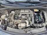 the engine of a car with its hood open and a car battery in it