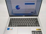 a laptop that is open on a white table