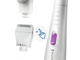 an image of a white electric shaver with a purple brush