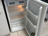 an open refrigerator that is sitting in a kitchen