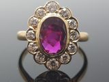 an image of a ring with a purple stone surrounded by diamonds