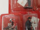four small plastic figurines of a man on a horse