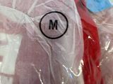 two stuffed animals wrapped in plastic bags on a table