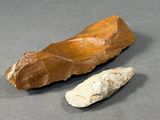 two pieces of stone on the table next to each other