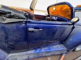 a blue car that is parked on the side of the road