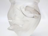a clear glass vase with a fish design on it