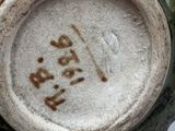 a close up of a vase with a number on it